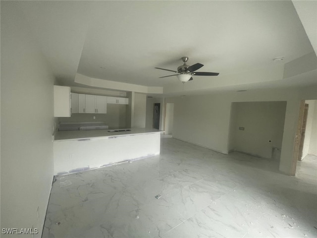 unfurnished living room with ceiling fan