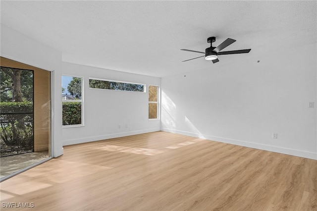 8950 Colonnades Ct E Unit 817, Bonita Springs, FL 34135 - unfurnished living room with light wood-style floors, baseboards, and a ceiling fan