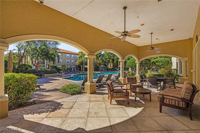 view of patio featuring a ceiling fan and a community pool
