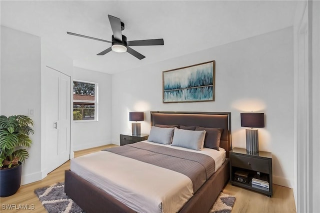8950 Colonnades Ct E Unit 817, Bonita Springs, FL 34135 - bedroom with light wood-style floors, baseboards, and ceiling fan