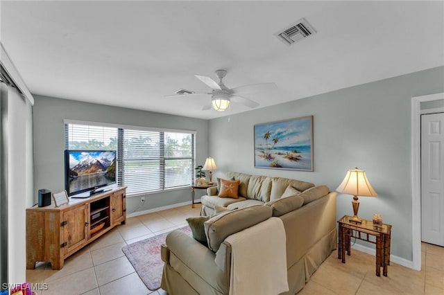 tiled living room featuring ceiling fan