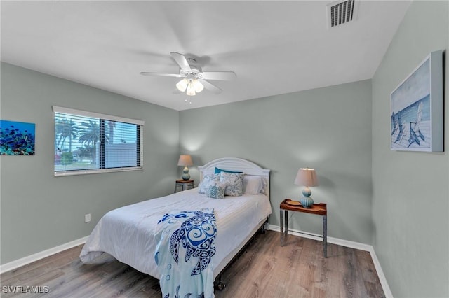 bedroom with ceiling fan and hardwood / wood-style flooring