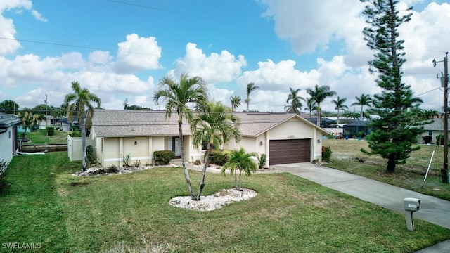 ranch-style home featuring a front lawn and a garage