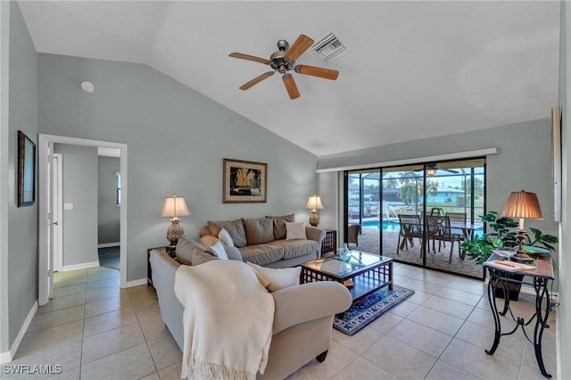 living room featuring ceiling fan, lofted ceiling, and light tile patterned flooring