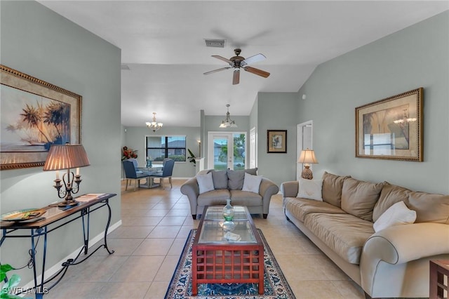 tiled living room with vaulted ceiling and ceiling fan with notable chandelier