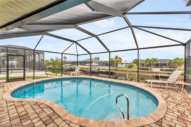 view of swimming pool with a lanai and a patio area