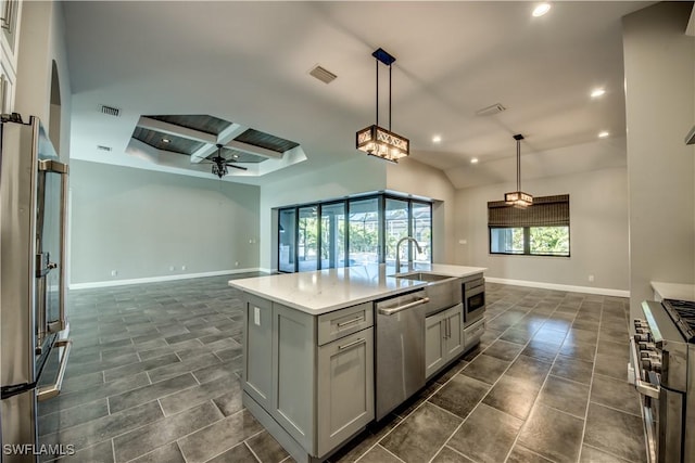 kitchen with gray cabinetry, open floor plan, recessed lighting, stainless steel appliances, and light countertops