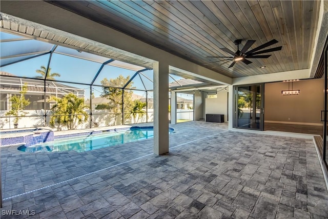 view of pool featuring ceiling fan, glass enclosure, an in ground hot tub, and a patio