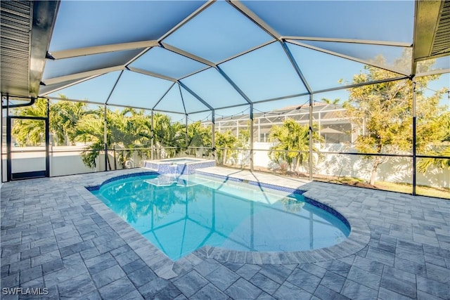 view of swimming pool with a lanai, an in ground hot tub, and a patio