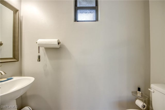 half bathroom with a sink and toilet