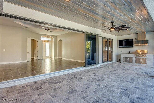 view of patio / terrace featuring grilling area, ceiling fan, and exterior kitchen