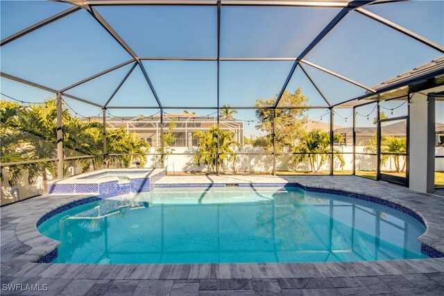 view of swimming pool featuring a patio area, glass enclosure, and an in ground hot tub