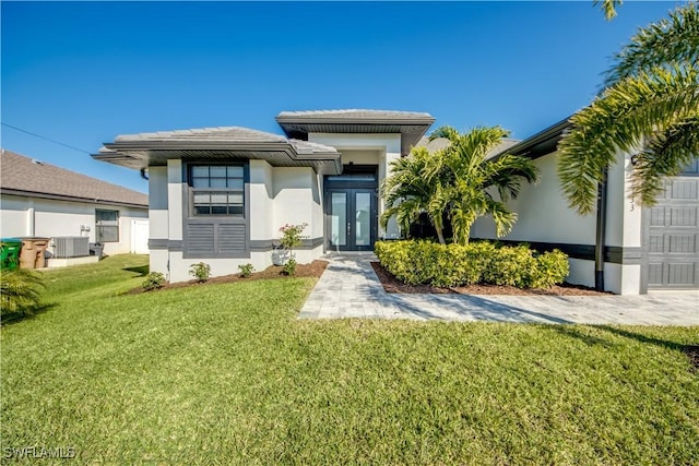 view of front of property featuring a front yard, central air condition unit, and french doors