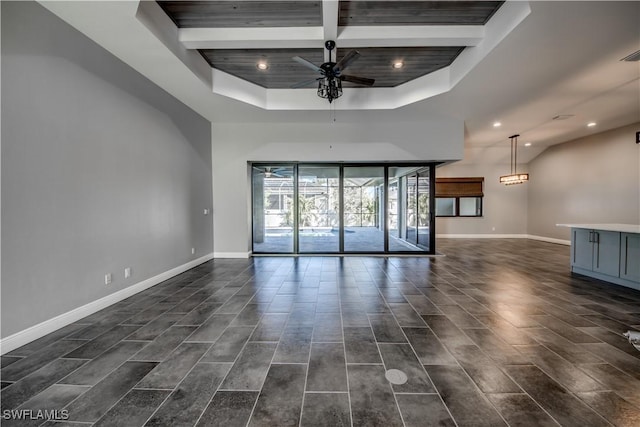 spare room featuring ceiling fan, wooden ceiling, and a raised ceiling