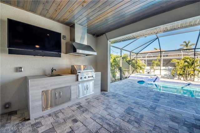 view of patio / terrace featuring exterior kitchen, a pool with connected hot tub, a sink, grilling area, and a lanai