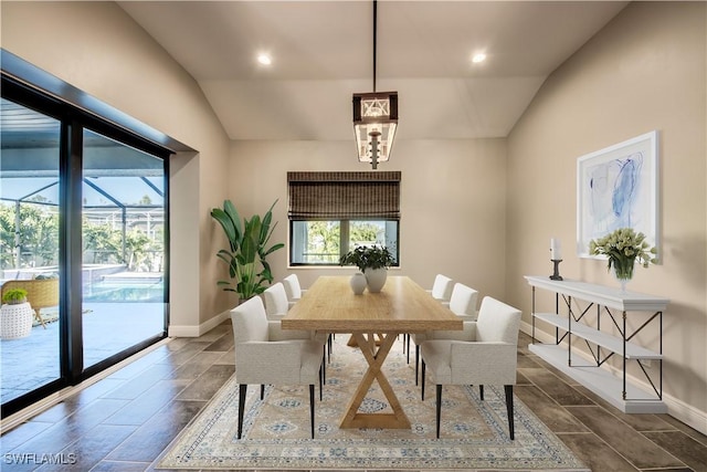 dining space with recessed lighting, baseboards, and lofted ceiling