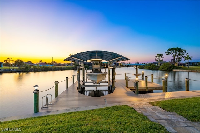 dock area with a water view and a yard