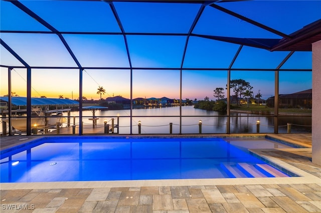 pool at dusk featuring a jacuzzi, a boat dock, a water view, a lanai, and a patio