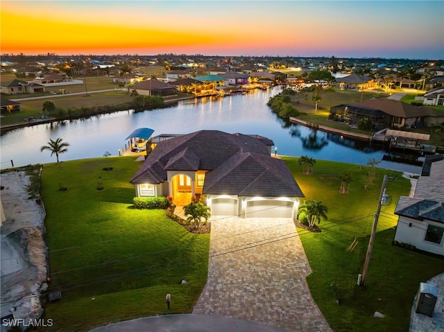 aerial view at dusk with a water view