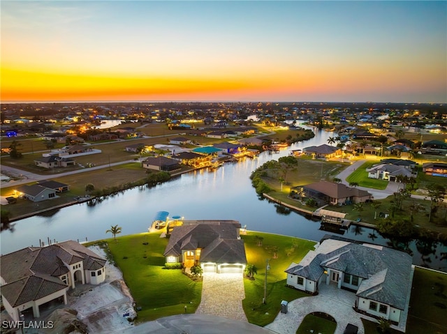 aerial view at dusk with a water view