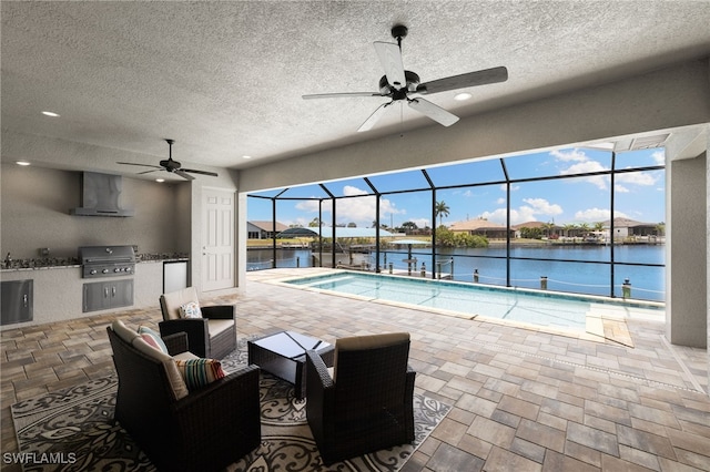 view of swimming pool featuring a water view, grilling area, and ceiling fan