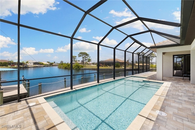 view of swimming pool with a patio area, a water view, a boat dock, and glass enclosure