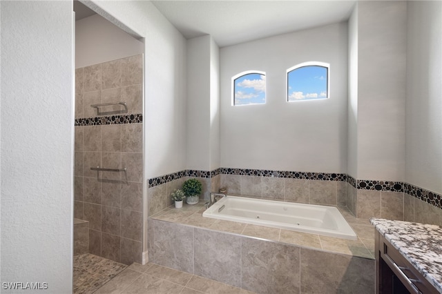 bathroom with vanity, tile patterned floors, and plus walk in shower