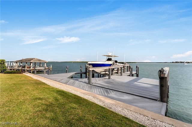 view of dock featuring a yard and a water view