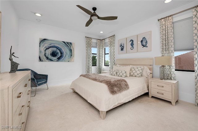 bedroom with ceiling fan and light colored carpet