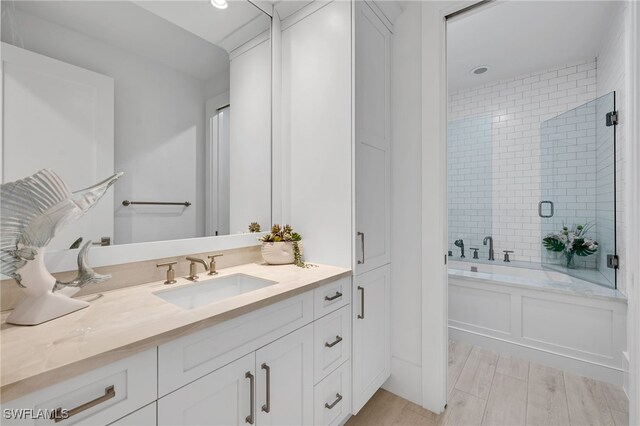 bathroom with separate shower and tub and vanity