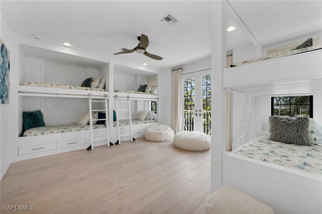 bedroom featuring ceiling fan, light hardwood / wood-style flooring, access to outside, and french doors