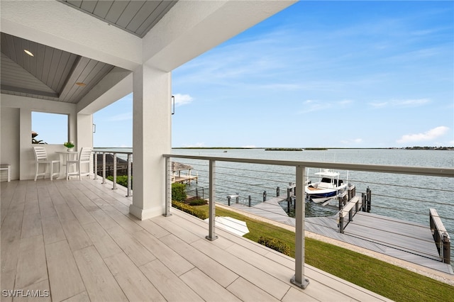 wooden terrace featuring a water view and a boat dock