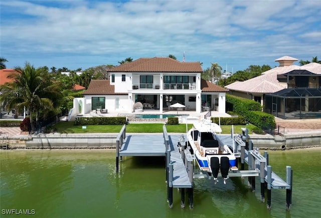 back of house featuring a patio, a water view, and a balcony