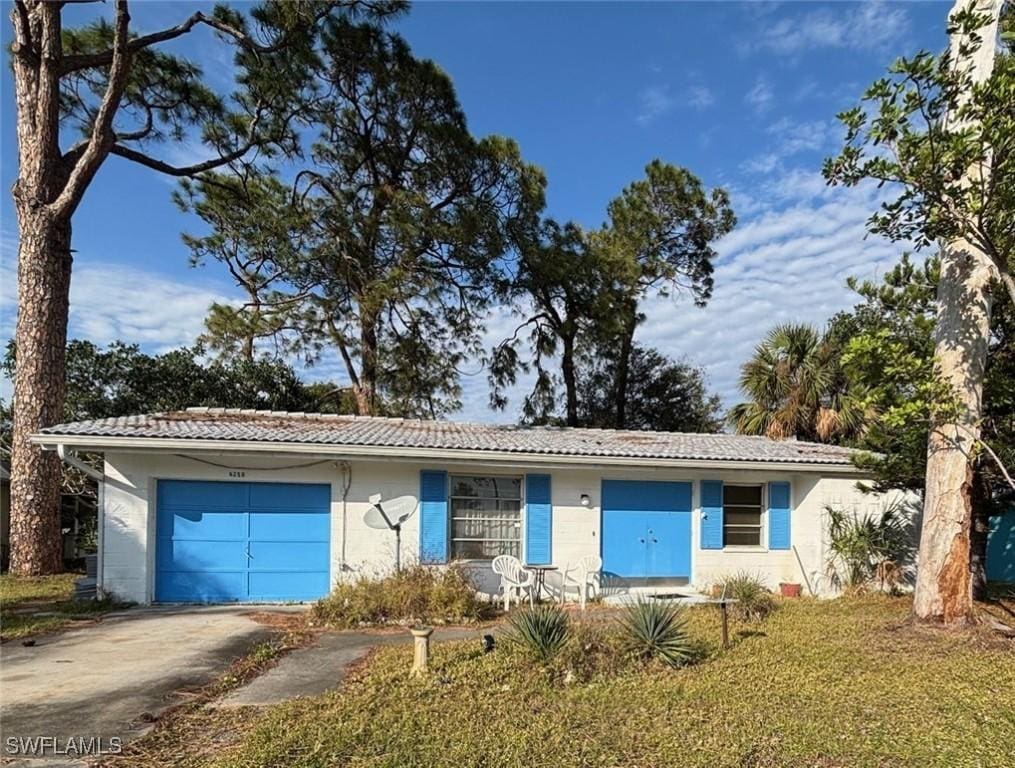 ranch-style house with a front lawn and a garage