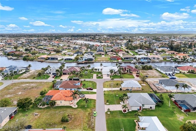 drone / aerial view featuring a residential view and a water view