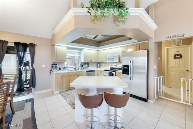 kitchen featuring visible vents, a sink, stainless steel appliances, light tile patterned flooring, and light countertops