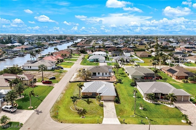 bird's eye view with a residential view and a water view