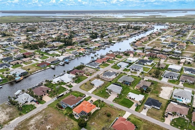 birds eye view of property with a residential view and a water view