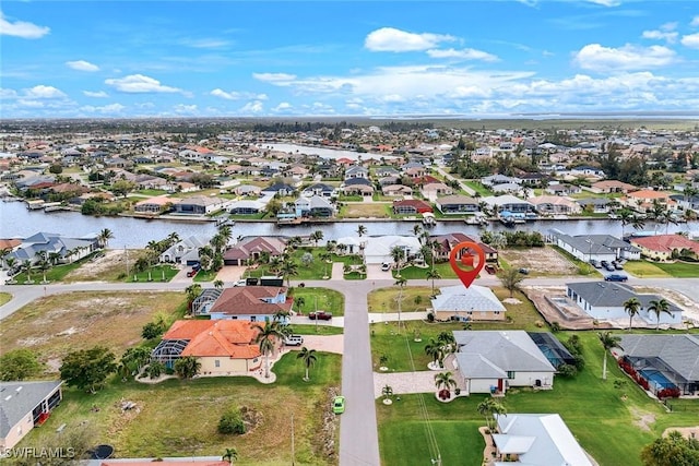 drone / aerial view with a residential view and a water view