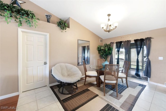 dining area featuring light tile patterned floors, baseboards, a chandelier, and vaulted ceiling