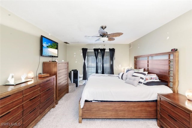 bedroom with a ceiling fan, light colored carpet, and visible vents