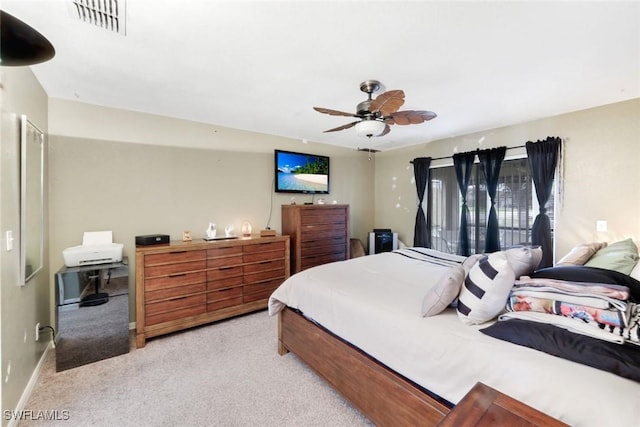 carpeted bedroom with visible vents, a ceiling fan, and baseboards