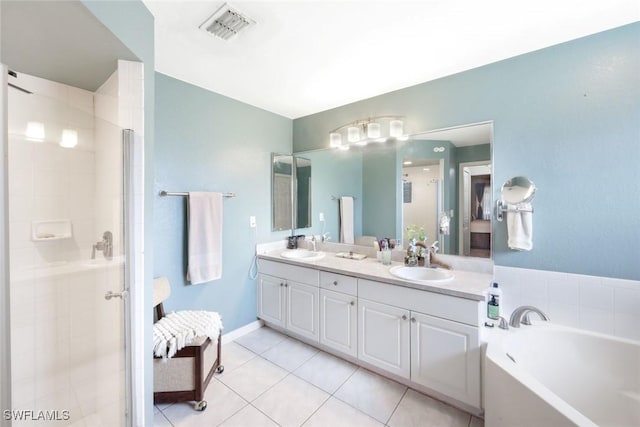 full bathroom with visible vents, a shower stall, and a sink