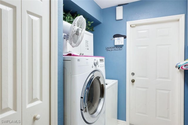 laundry area featuring washer and clothes dryer and laundry area