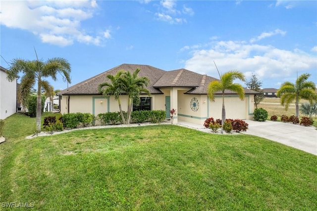 ranch-style home with a garage and a front lawn