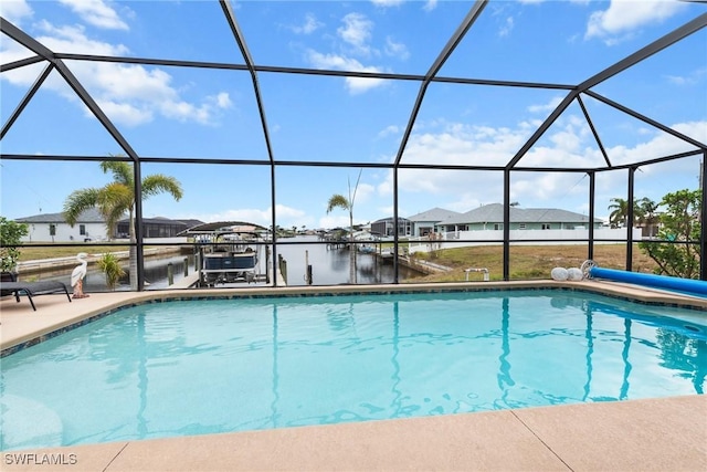 view of swimming pool with a water view, a lanai, and a dock