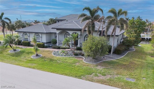 single story home featuring a front lawn and a porch