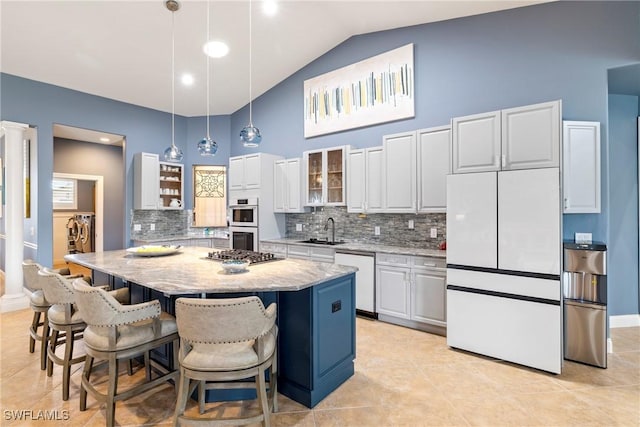 kitchen with glass insert cabinets, light stone counters, white appliances, white cabinetry, and a sink