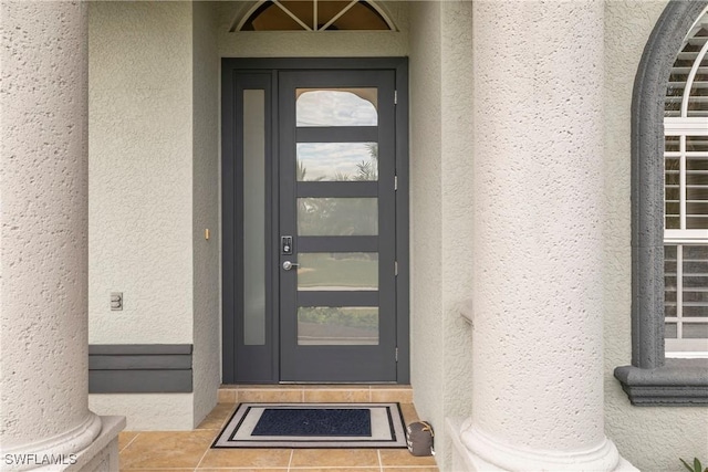 entrance to property featuring stucco siding