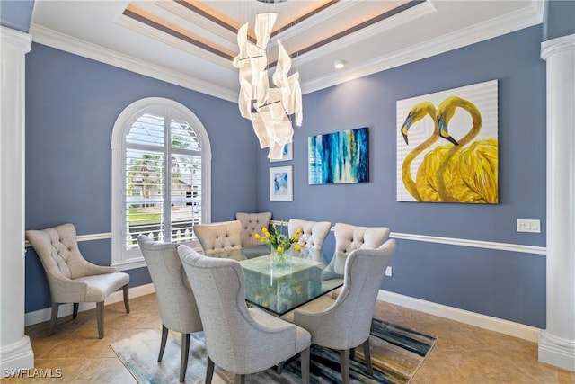 tiled dining room with ornamental molding, baseboards, ornate columns, and a raised ceiling
